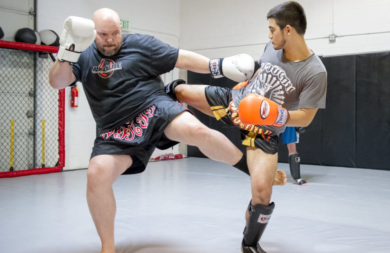 Absolute MMA Classes and Training in West Jordan, UT - Owner Rob Handley with Student