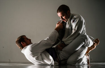 Brazilian jiu-jitsu BJJ training sparing on the tatami two fighters in guard position in training